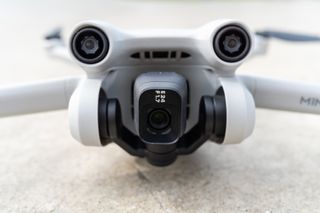The DJI Mini 3 Pro drone resting on the ground