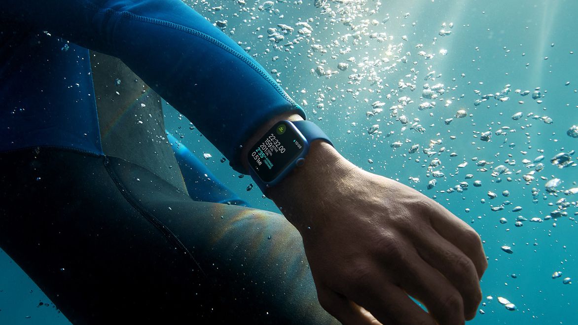 Apple Watch Series 7 being word on a man&#039;s wrist underwater