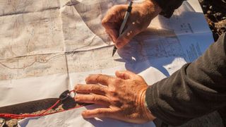 Man plotting a route on a map