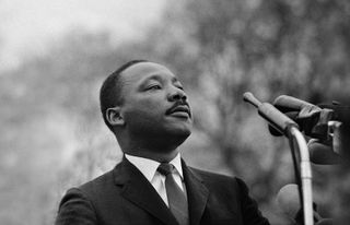Dr. Martin Luther King, Jr. speaking before crowd of 25,000 Selma To Montgomery, Alabama civil rights marchers, in front of Montgomery, Alabama state capital building. On March 25, 1965 in Montgomery, Alabama.