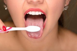 Woman brushing teeth