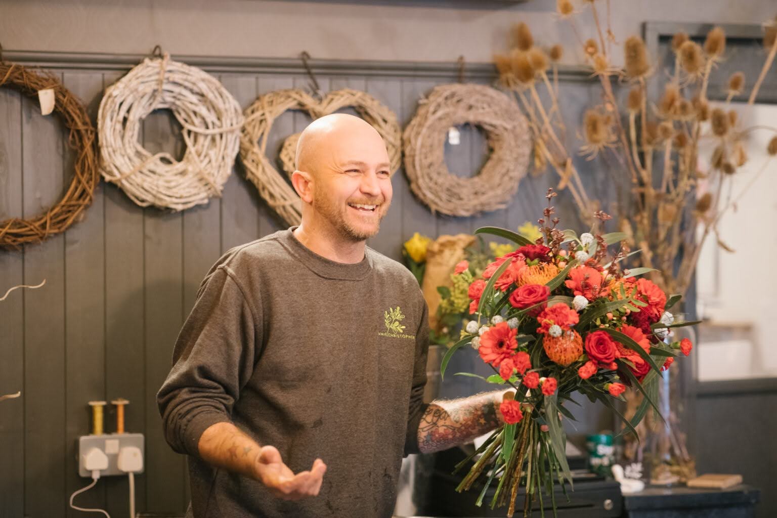 an image of the interflora florist, Jamie, holding a bouquet of flowers