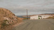 The house sits below a crest on a quiet road on Cruit Island on the Atlantic coast