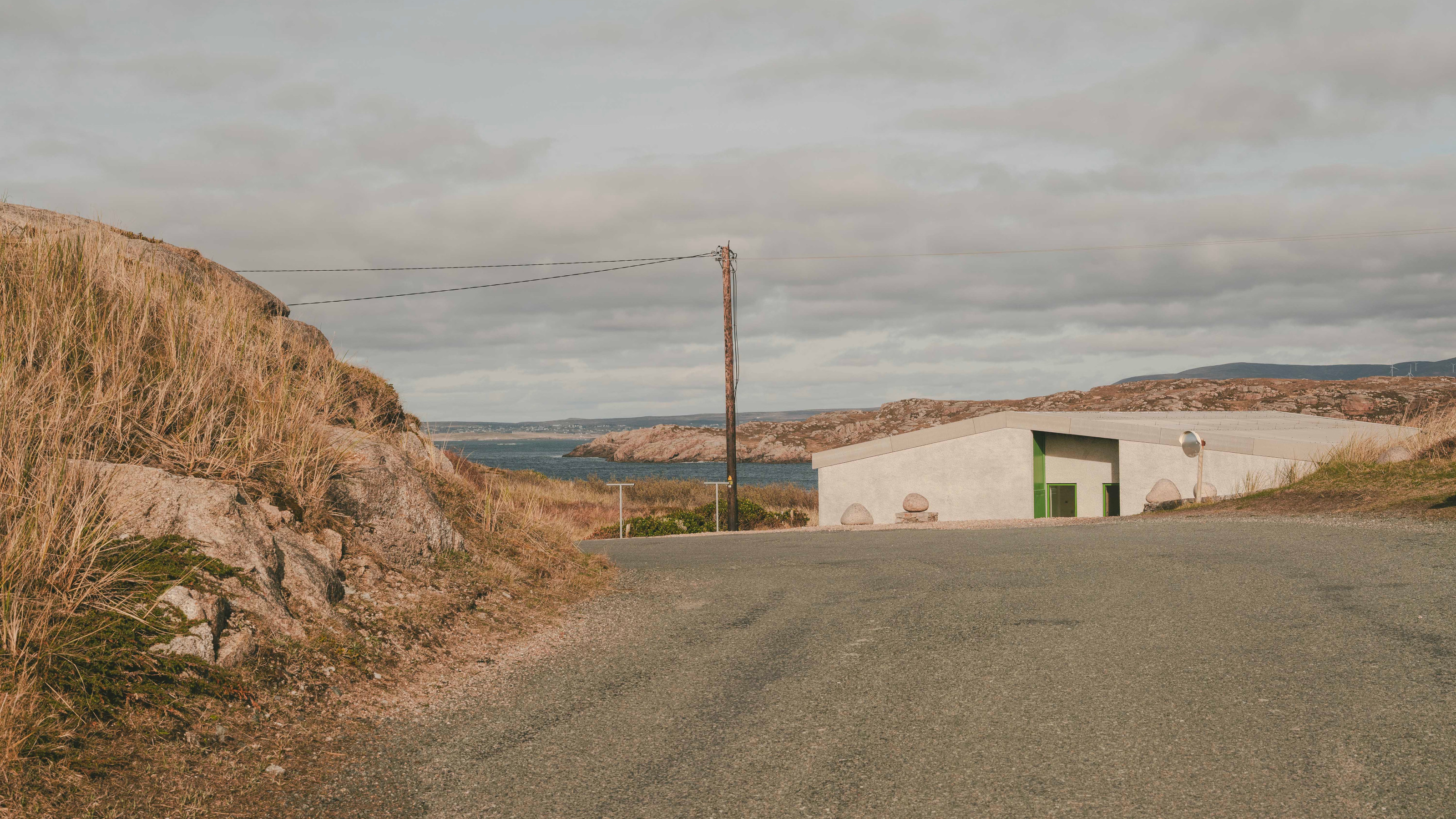 The house sits below a crest on a quiet road on Cruit Island on the Atlantic coast
