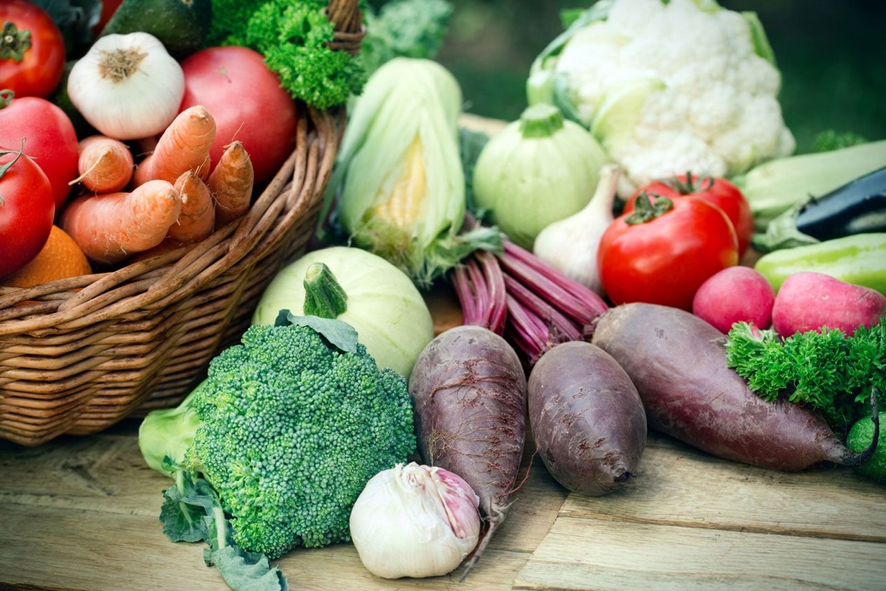 Basket And Table Full Of Fresh Vegetables