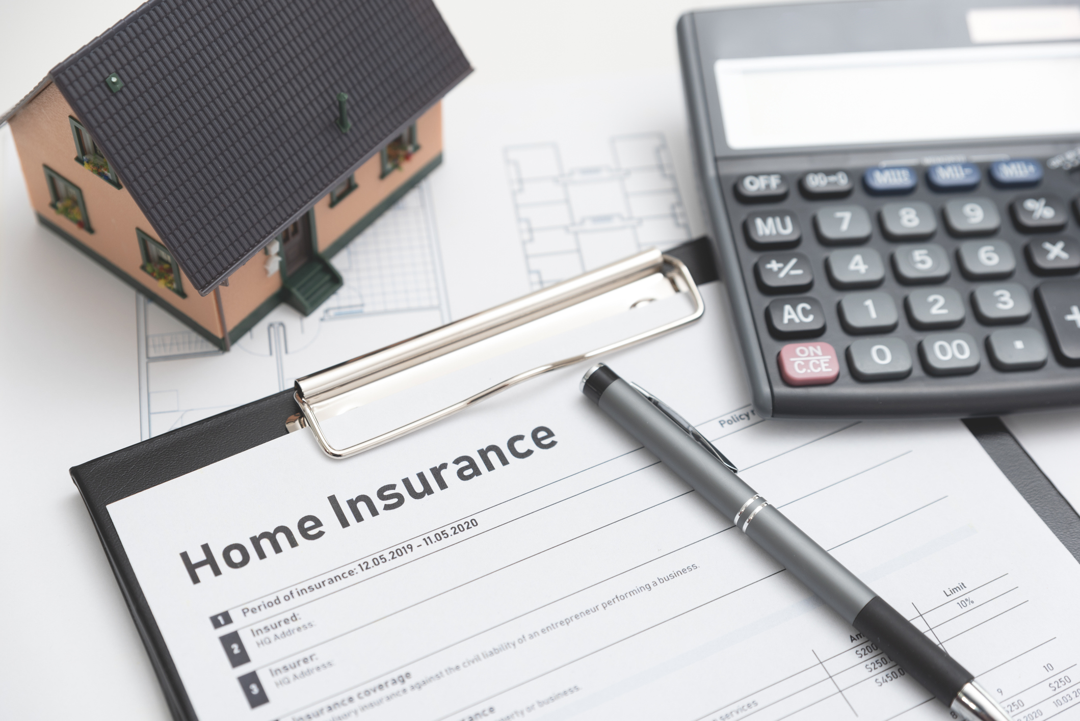 Home insurance form on the table. Assurance and home safety concept.