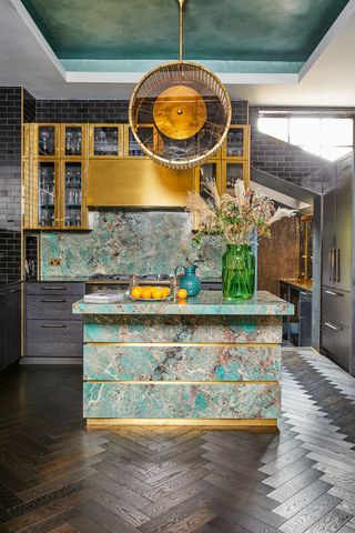 ornate kitchen pendant in a green marble kitchen