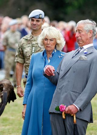 Prince Charles, Prince of Wales and Camilla, Duchess of Cornwall react as Zephyr, a Bald Eagle, and mascot of The Army Air Corps flaps its wings as they visit the Sandringham Flower Show on July 29, 2015 in King's Lynn, England