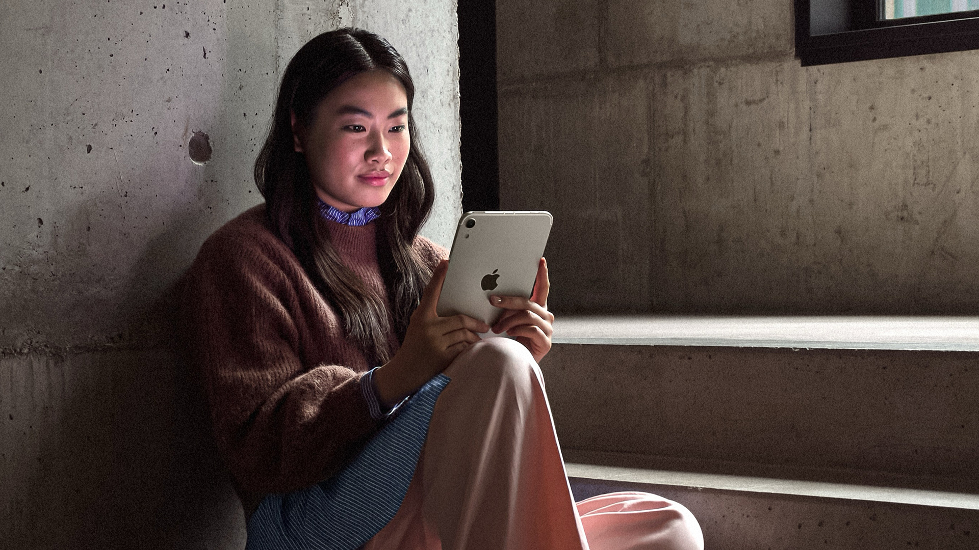 Woman holding 2026 iPad mini