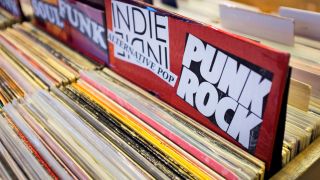 Cyber Monday vinyl deals: a stack of indie and punk vinyl records in a record store