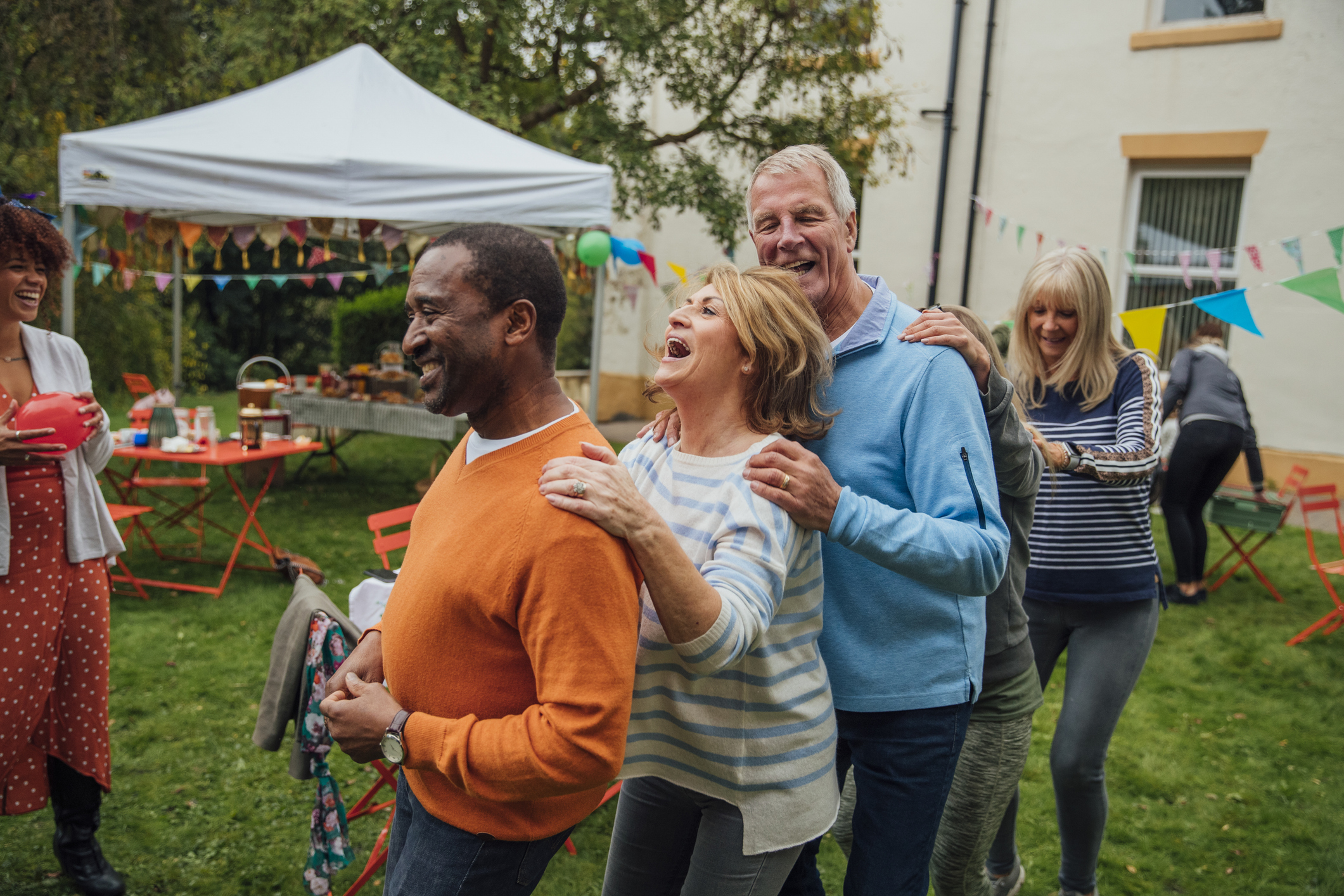 Older adults at a backyard party 