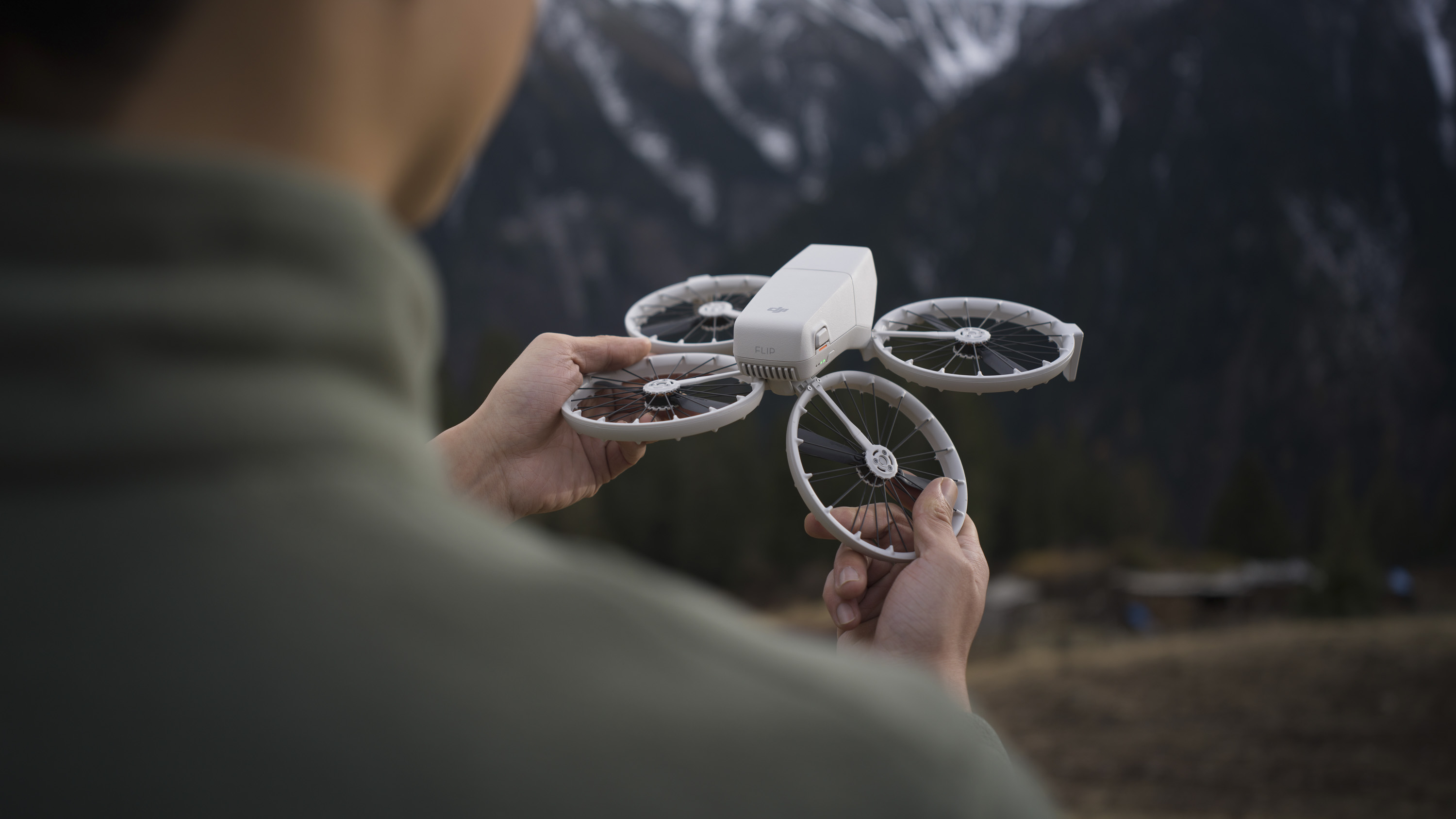 Person unfolding the propellors of the DJI Flip drone