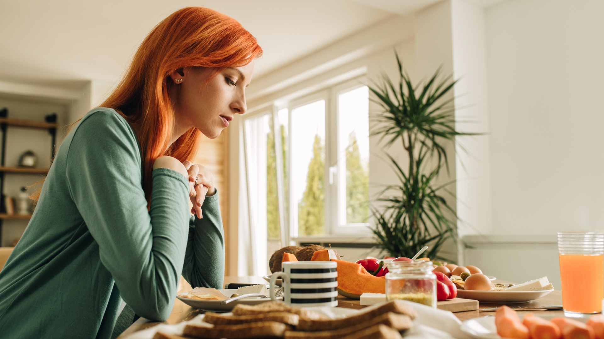 Woman sits at a breakfast table