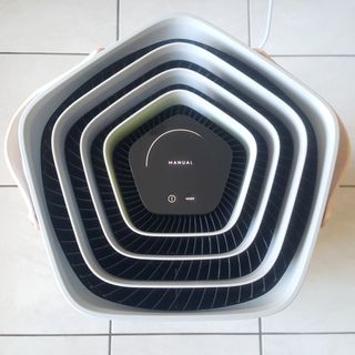 The AEG AX91-604GY Connected Air Purifier seen from above showing a hexagonal filter and LED display panel