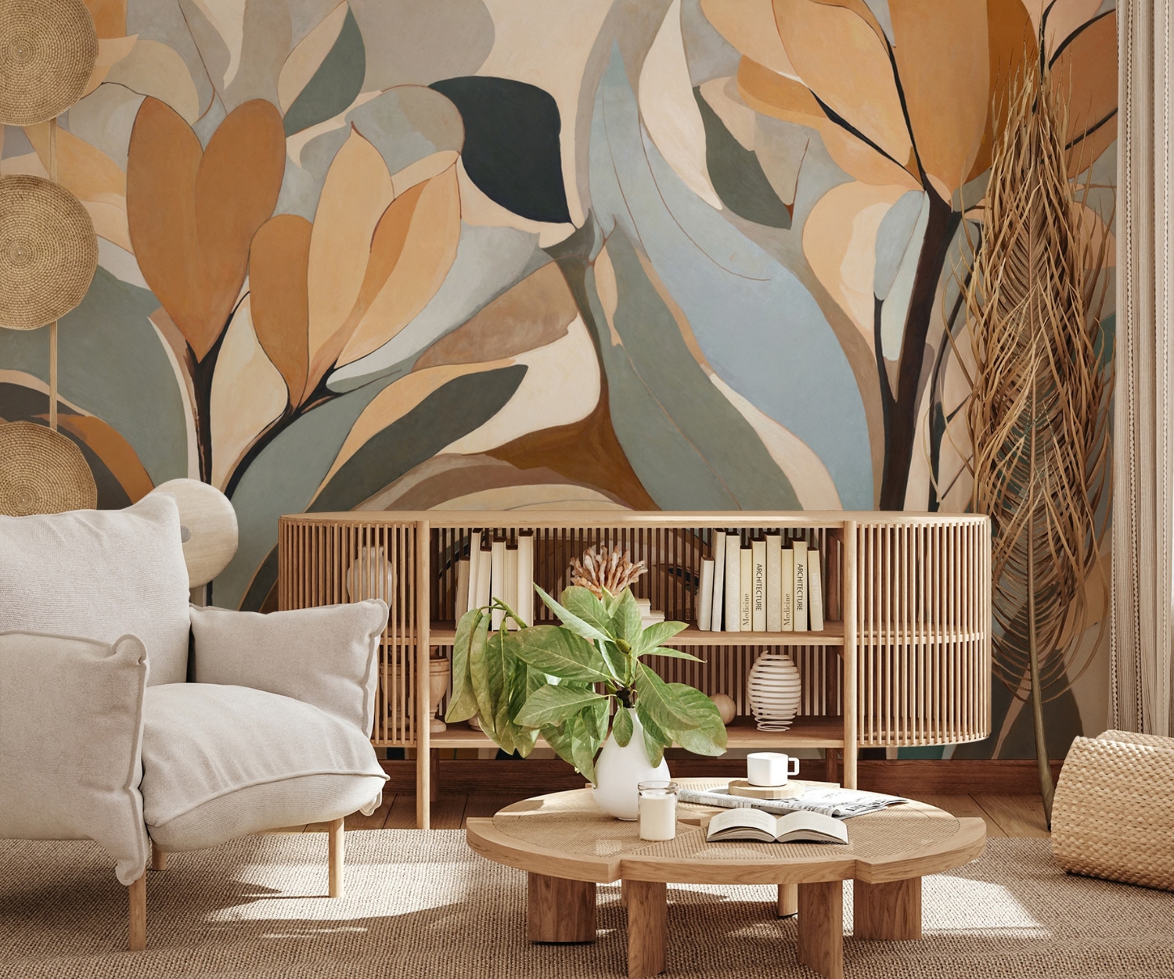 Abstract mural of peach, sage and blue leaves behind slatted oak sideboard, cream armchair and round oak coffee table