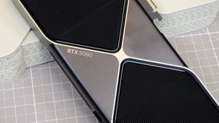 An Nvidia GeForce RTX 5080 leaning against its retail packaging with the RTX 5080 logo visible