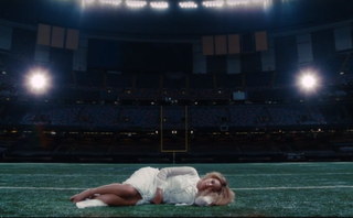 Beyonce laying in a stadium