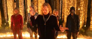 Sir Lord Jimmy shooting finger guns in front of Jimmy cult in a ring of fire in 28 Years Later: The Bone Temple