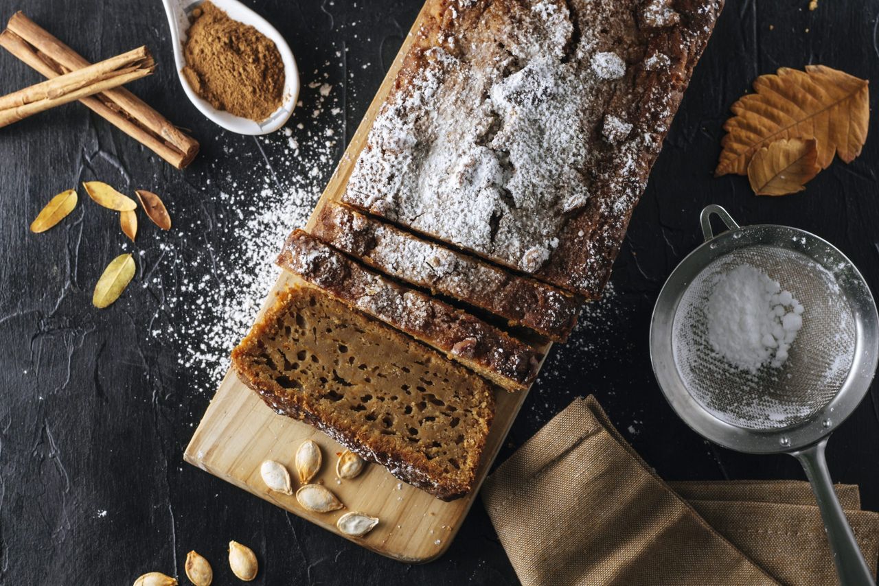 Pumpkin sponge cake cut into slices with powdered sugar on top