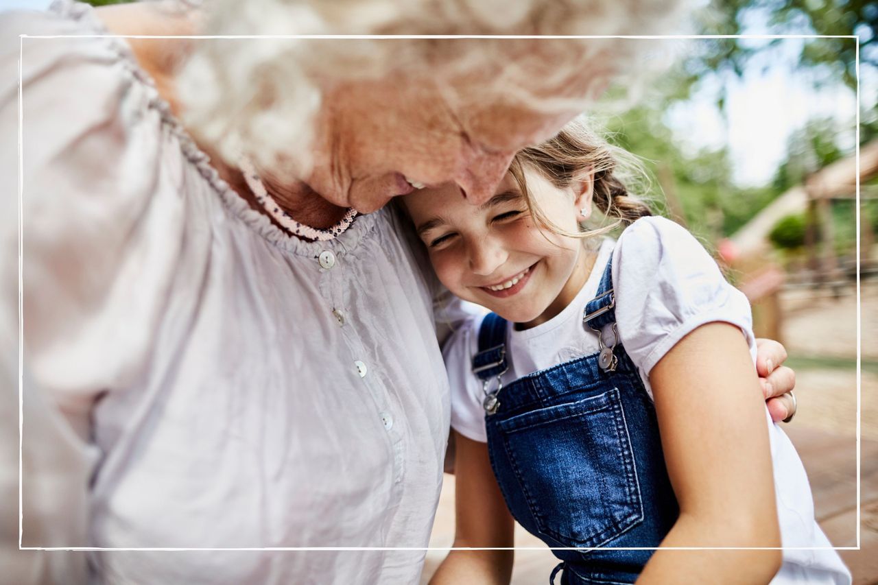 Grandmother and granddaughter hugging while on holiday