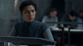 Aoife Hinds sits at a table with a questioning look in Dune: Prophecy - S1 E2 "Two Wolves."