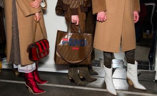 A clos-up of the Fendi x Fila bag, along with block cowboy boots in red, green and white