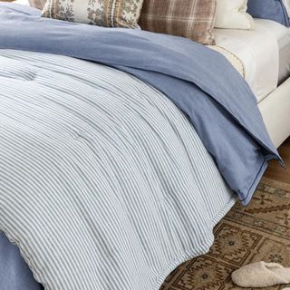 A blue and white striped quilt from McGee & Co.