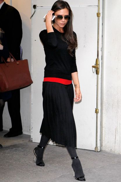 Victoria Beckham wears tights and sandals