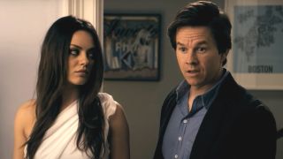 Mila Kunis looking over with anger as Mark Wahlberg looks surprised in Ted.