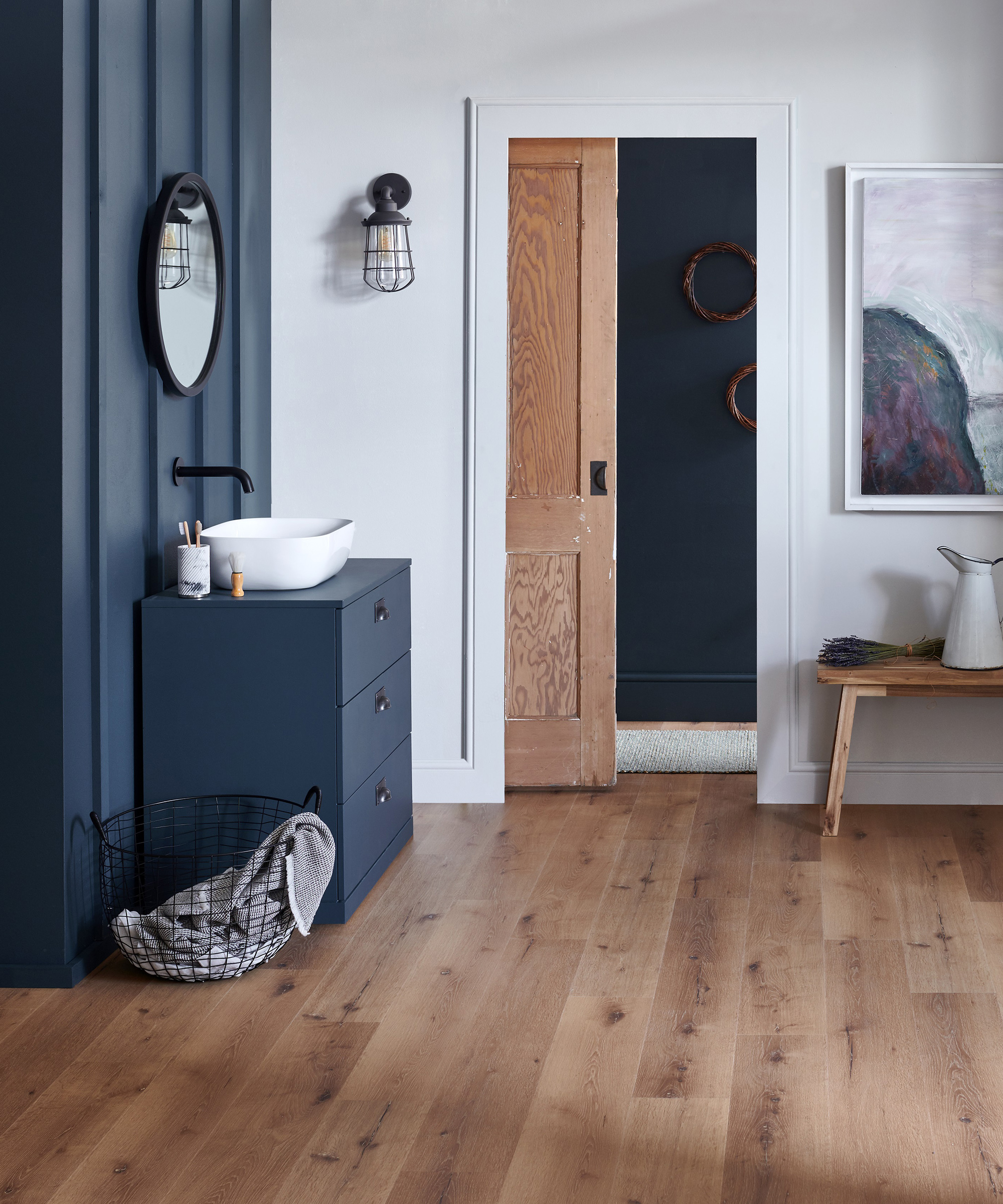 blue ensuite bathroom with wooden flooring