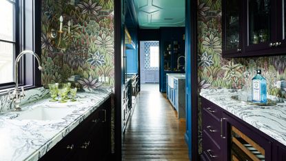 kitchen with wallpaper and marble worktops