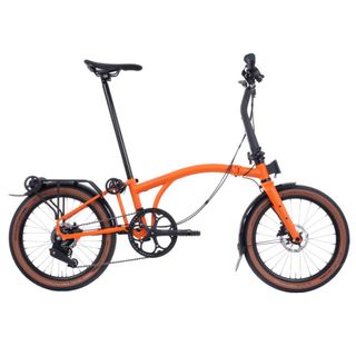 The Brompton G-line, a folding bike able to tackle gravel riding, shown here in Orange.