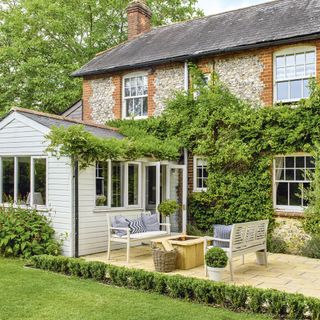 garden with green foliage cushion brick wall