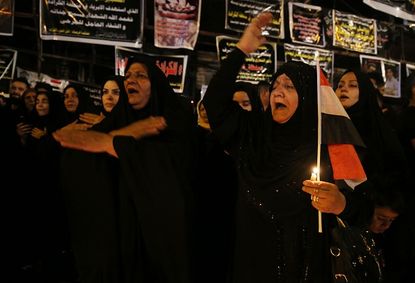 Mourners at a candlelight vigil for the victims of Sunday's suicide bombing in Baghdad.