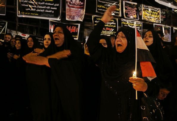 Mourners at a candlelight vigil for the victims of Sunday&amp;#039;s suicide bombing in Baghdad.