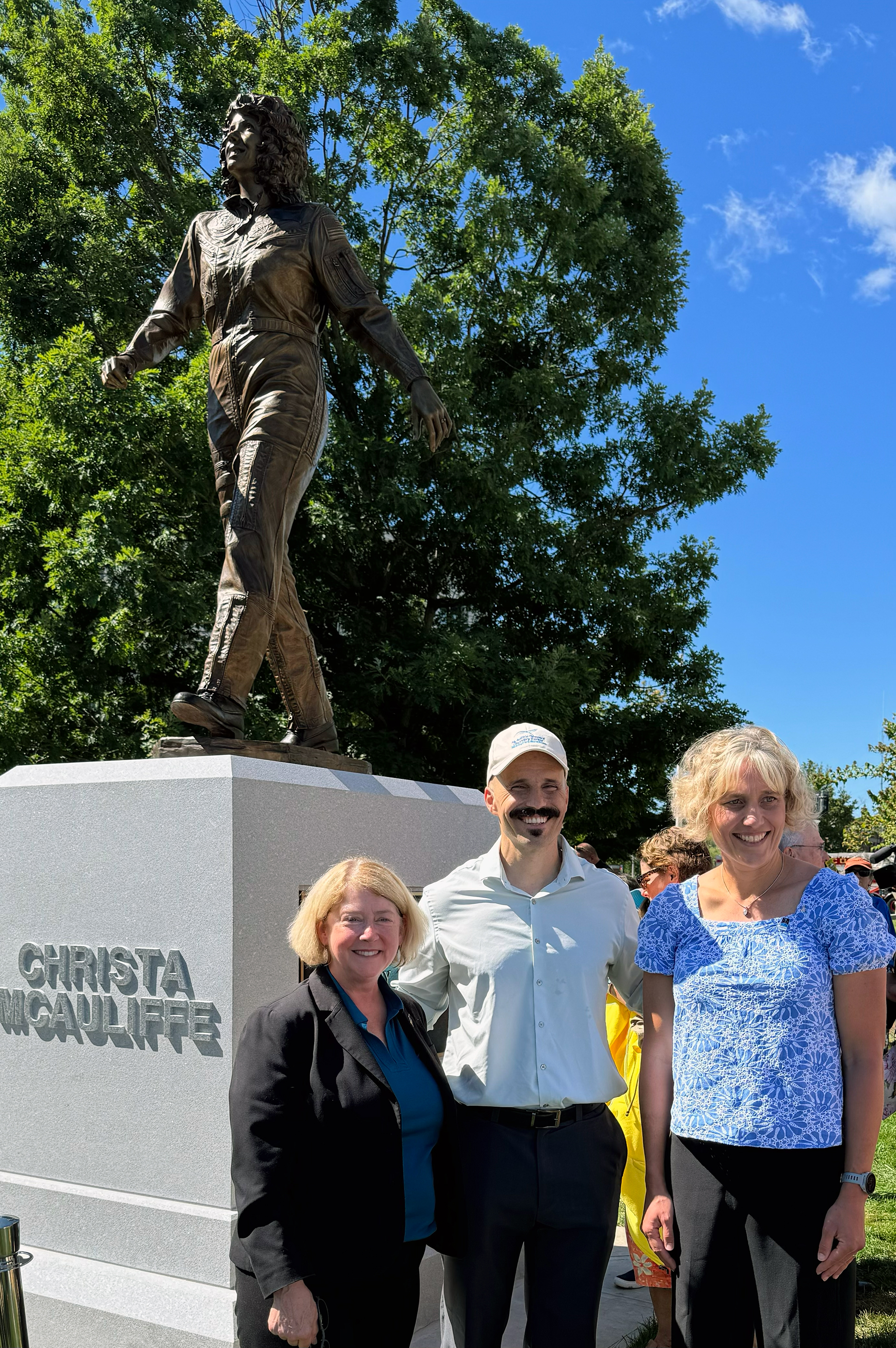 Sculptor Benjamin Victor poses in front of his statue of Christa McAuliffe with NASA deputy administrator Pam Melroy (at left) and NASA educator-astronaut Dottie Metcalf-Lindenburger at the New Hampshire State House, Monday, Sept. 2, 2024.