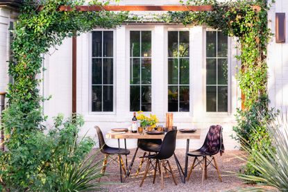 plants that like full sun and heat; outdoor dining area with vine covered pergola by Eden Garden Design