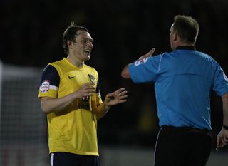 Adam Chapman of Oxford United makes a point to referee Mark Brown in a game against Northampton Town in April 2012.