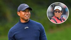 Main image of Tiger Woods in a navy blue Sun Day Red sweater and cap - Notah Begay wears NBC broadcasting gear and cap (inset)
