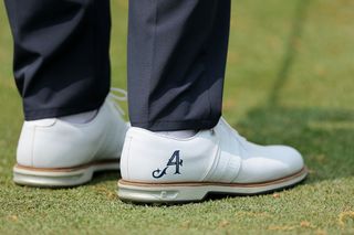 Dustin Johnson's shoes with a 4 Aces logo