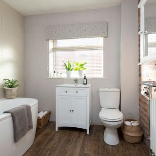bathroom with wooden floor and commode