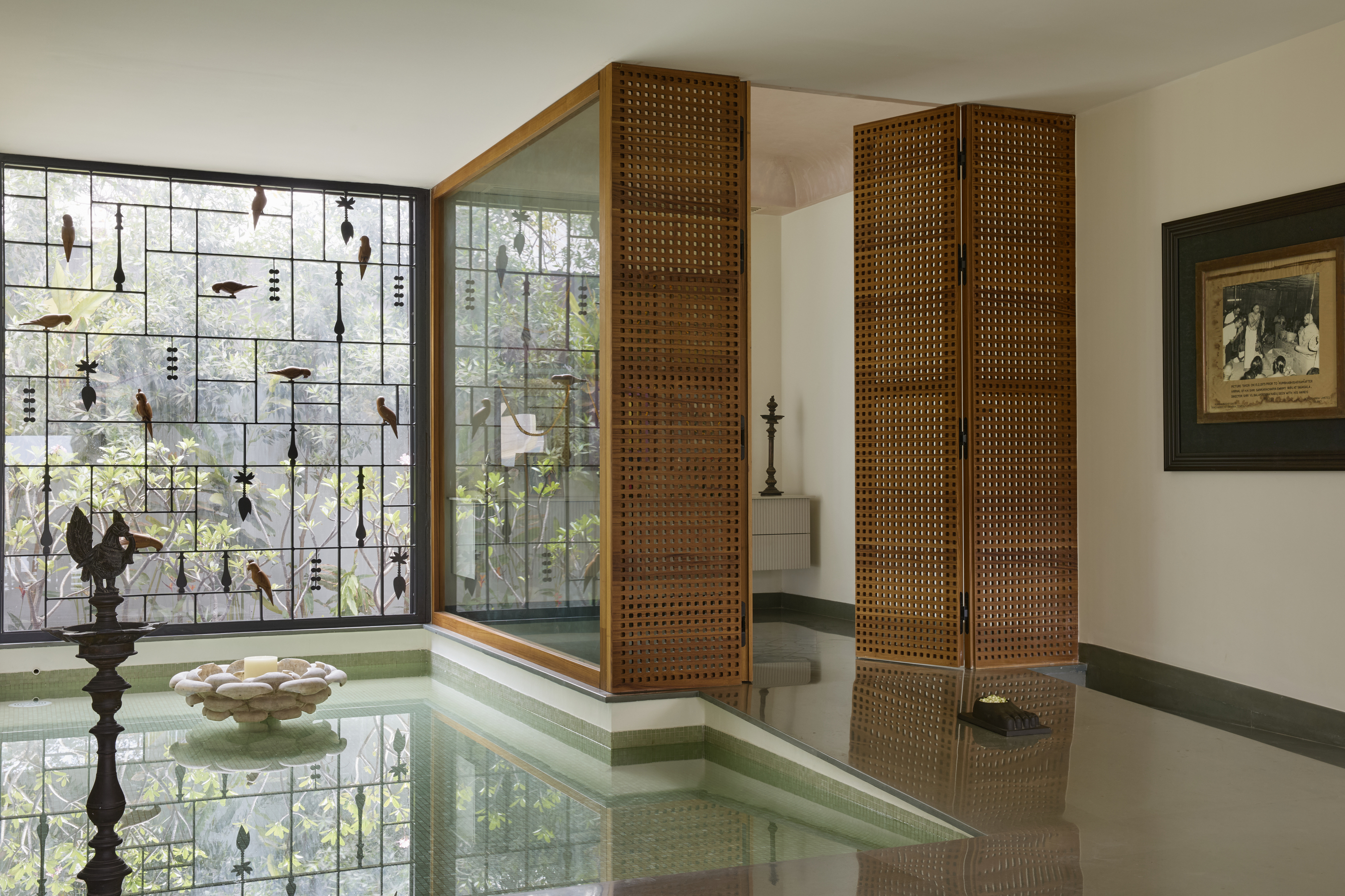 A prayer room, with a latticed area, and a small water body