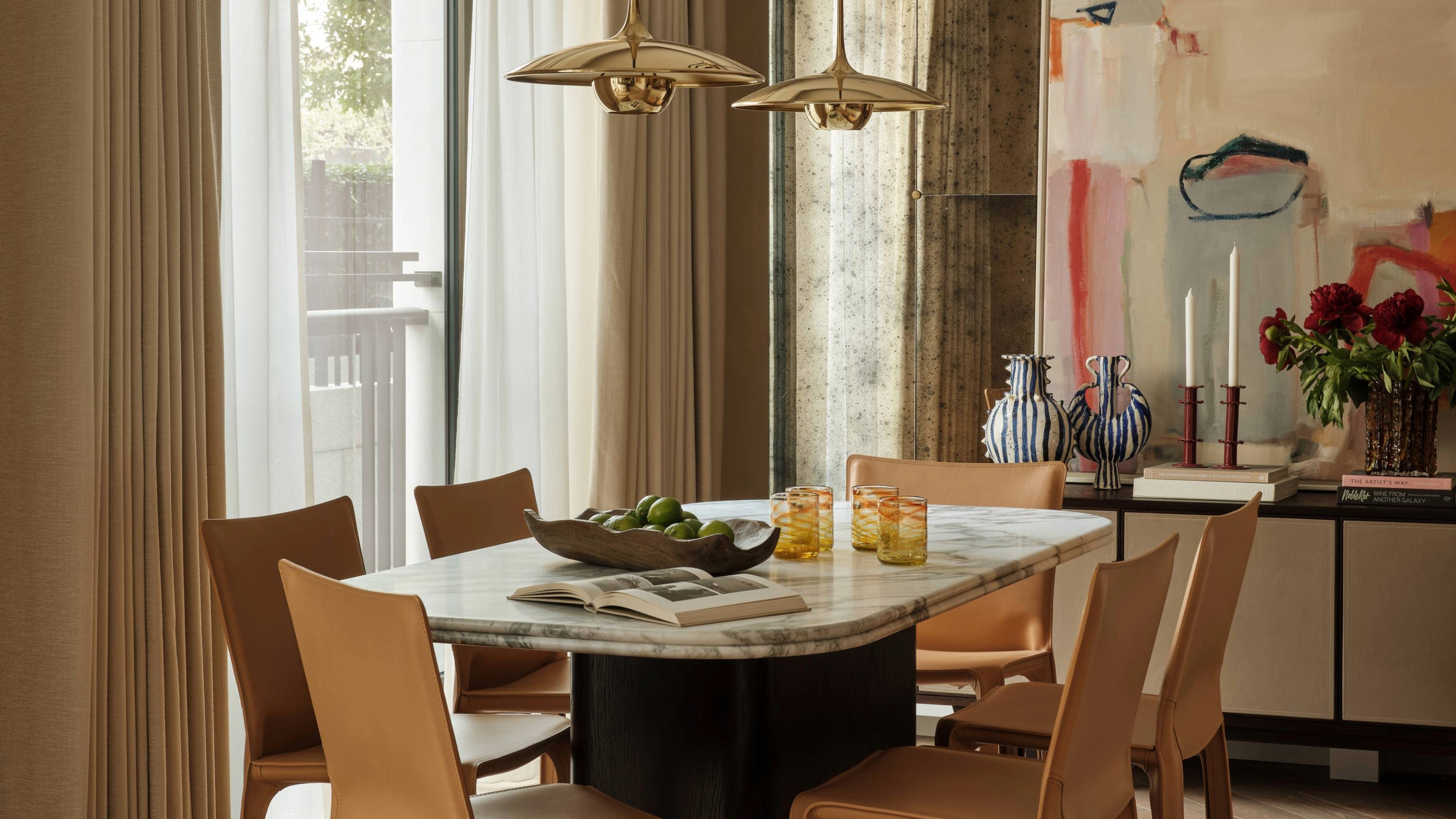 Contemporary dining room with marble table and leather chairs