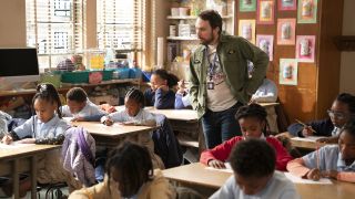 Charlie looking at children doing their schoolwork It's Always Sunny in Philadelphia crossover with Abbott Elementary