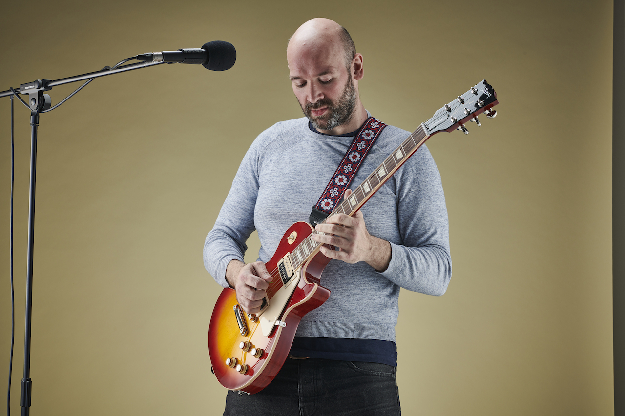 Chris Bird singing and playing guitar