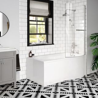 bathroom with white brick tile wall black window bathtub and designed fooring