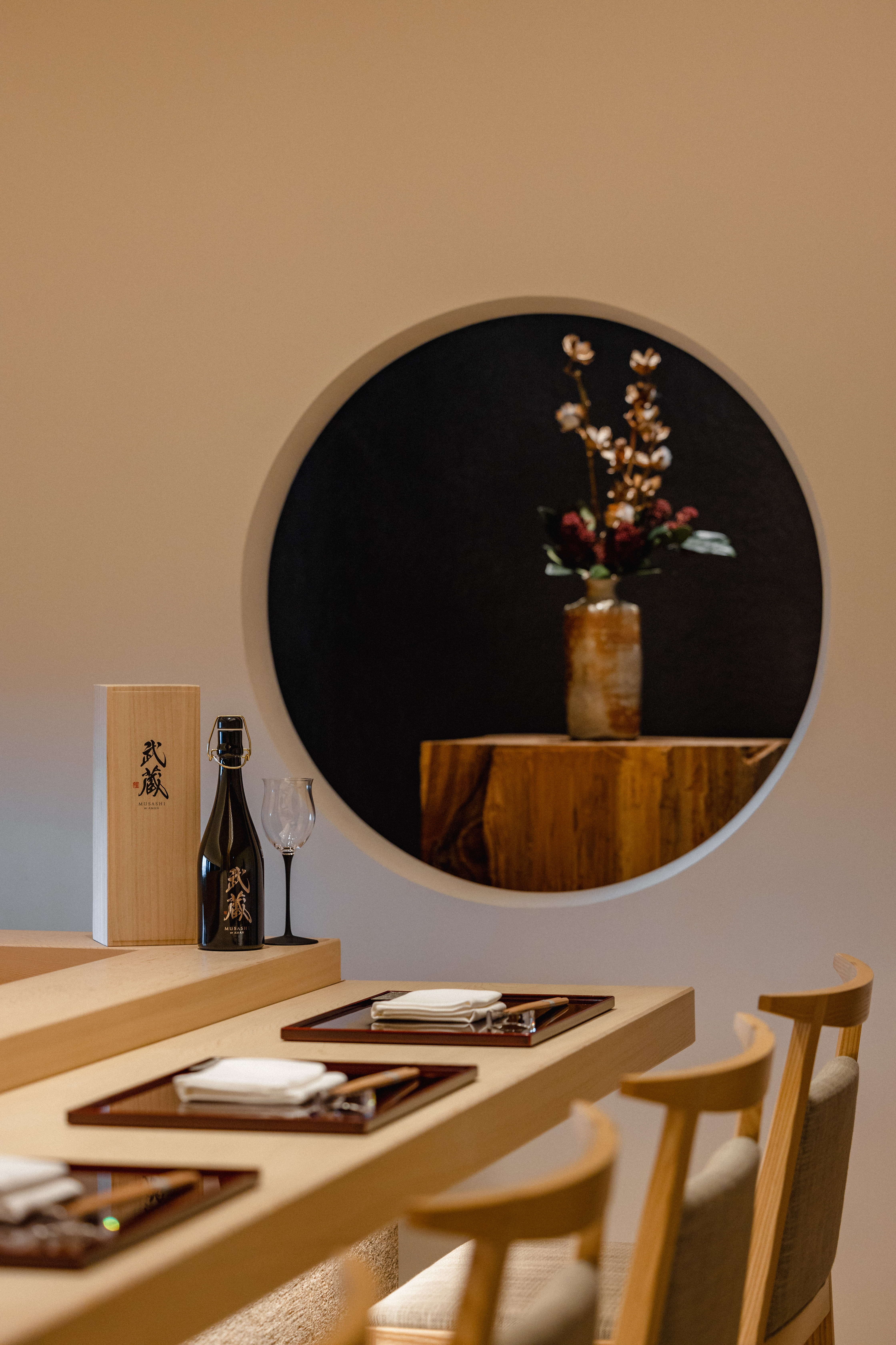 view of a serene hotel in tokyo, adorned with wooden furnishing, washi paper and natural stone touches