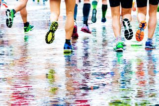 Marathon participants running in the rain