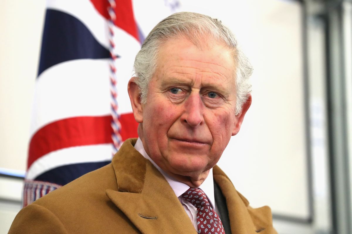 King Charles in front of a union jack flag