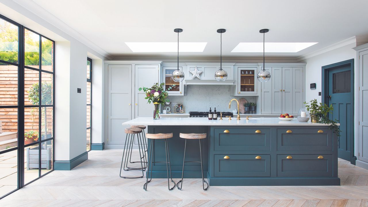 Navy and light blue shaker kitchen with pendant lights over island